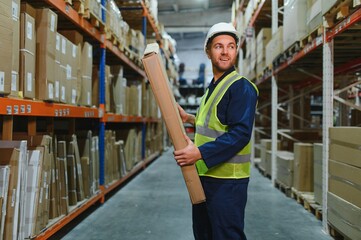 portrait of a smiling young warehouse worker working in a cash and carry wholesale store