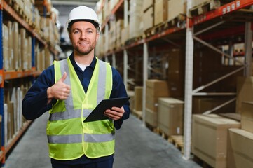 Portrait of warehouseman with clipboard checking delivery, stock in warehouse