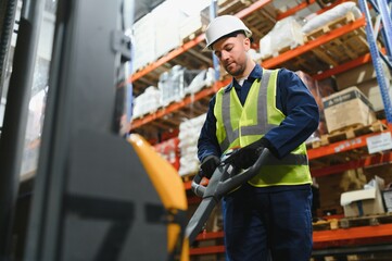 Storehouse manager supervising the lift truck operator