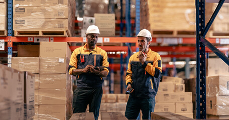 Warehouse manager, store inspector checking stock on storage shelf from inventory checklist. Two...