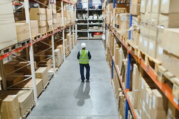 Young man working at a warehouse with boxes