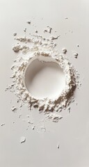 White flour dusted in a circular pattern on a white surface