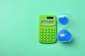 Calculator and hourglass, concept of paying taxes and loan terms, mortgage