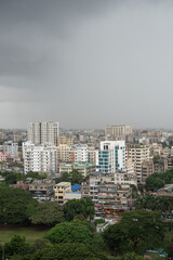 High-Rise Buildings and Dense Urban Skyline with Lush Greenery under Overcast Sky in Modern Metropolitan Cityscape