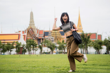 Joyful solo Southeast Asian woman teenager and blogger enjoys world travel cultural experience....