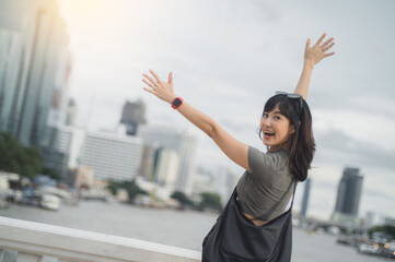 Happy young southeast asian woman teenager blogger on solo world travel. local cultural experience for explorer in Bangkok Thailand. Asia tourism concept with smartphone by Chao Phraya river
