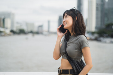 Solo Southeast Asian woman teenager blogger enjoy world travel tourism Bangkok Thailand. happy...