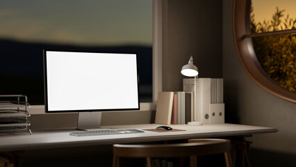 Blank screen computer with file folder and lamp on wooden table with chair in living room or bedroom