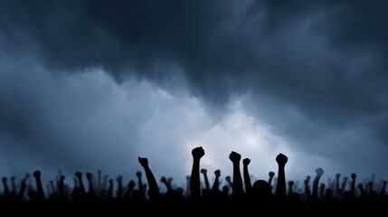 Fototapeta premium Crowd silhouetted against a dark, stormy sky, raising fists in protest, embodying the spirit of civil unrest and the ongoing fight for rights and justice