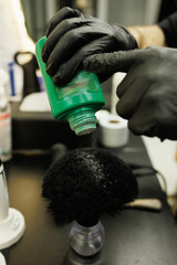 Close up of barber pouring powder on neck brush