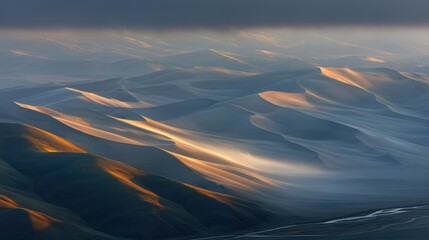 Snowy Mountain Range Under Dramatic Cloudy Sky During Sunset