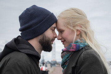 Closeup portrait of young couple. Man and woman in love, outdoors lifestyle portrait