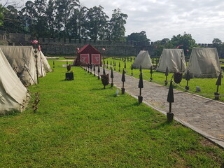 Ancient Roman Encampment on Green Grass at a Historical Reenactment in Roman Fortress. Ancient...