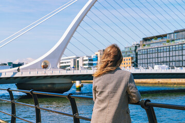 Fototapeta premium Woman looking at Samuel Beckett's bridge in Dublin Ireland