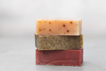 Close up natural soap bars in earthy tones on a minimalist concrete gray background