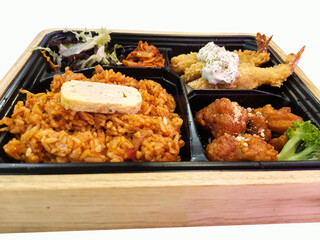 Delicious bento box with fried shrimp, fried rice, chicken, salad and vegetables.
Korean bento set with wooden box.
Isolated white color.