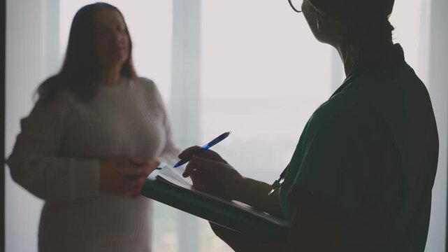 female doctor listening to complaints writing medical case report diagnosis, prescription for senior woman patient in office clinic, health records for treatment. healthcare worker talking to elderly