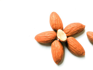 Roasted almonds in flower shape.
Isolated on white background.
Healthy snack concept, ketogenic diet food.
