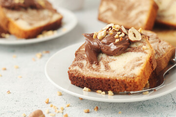A piece of marble biscuit with chocolate cream and nuts
