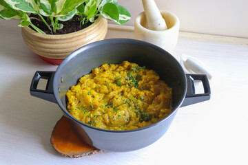 Sweet and tangy Pumpkin Oambal or chutney made with red pumpkin, jaggery, raw mango, onion seeds, garlic, chili, and curry leaves. A traditional Maharashtrian dish, perfect for a festive thali meal.
