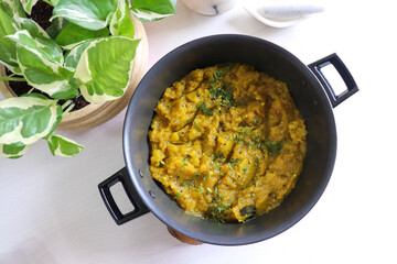 Sweet and tangy Pumpkin Oambal or chutney made with red pumpkin, jaggery, raw mango, onion seeds, garlic, chili, and curry leaves. A traditional Maharashtrian dish, perfect for a festive thali meal.