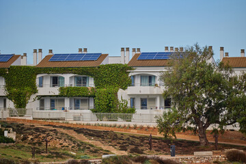 Modern eco-friendly apartments with solar panels in coastal Mediterranean town
