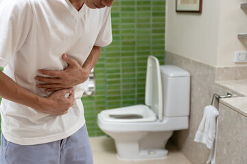 Constipation and diarrhea in bathroom. Hurt man touch belly  stomach ache painful. colon...