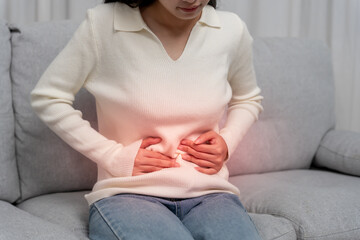 stomach ache. Asian women have abdominal pain, indigestion, gastritis, menstrual cramps,...