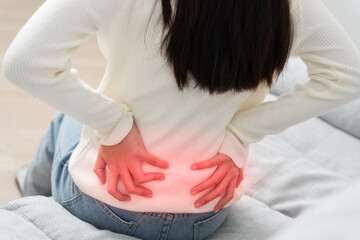 woman holding back while and suffer from unbearable pain health and problems, chronic back pain,...