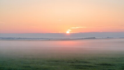 Obraz premium Pink Sunrise Over Foggy Field – Tranquil Early Morning Landscape with Mist