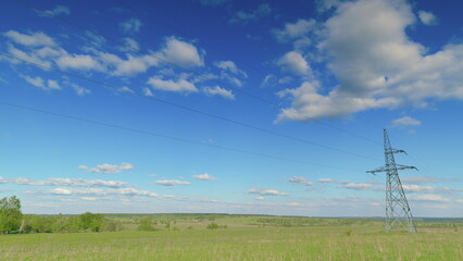 A breathtaking sunny landscape featuring a serene view of power lines against clear skies Time...