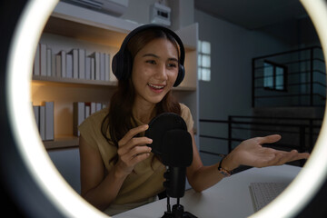 Engaging Online Presence. Young woman smiling while interacting with her audience through a...