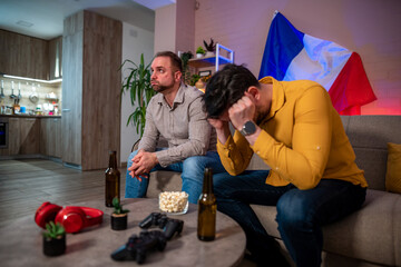 Friends face disappointment during a tense home football game