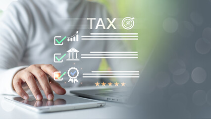 Hand using tablet and laptop with tax checklist and quality icons, representing digital tax...