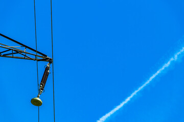 Large electricity pylon power pole with blue sky in Austria.