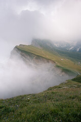 Mountain slopes covered in mist with dramatic ridge and fog layers
