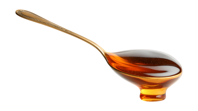 Filling a measuring spoon with honey isolated on a white background