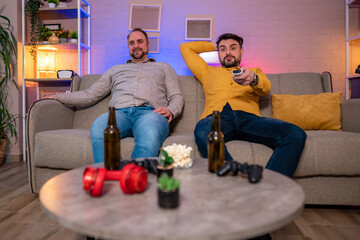Friends enjoying a relaxed evening at home watching television
