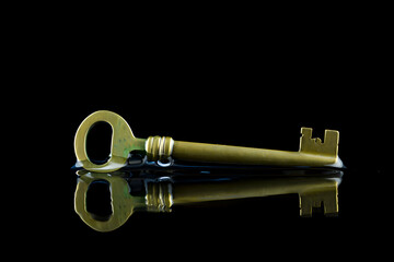 Vintage Key with Reflection on Dark Background