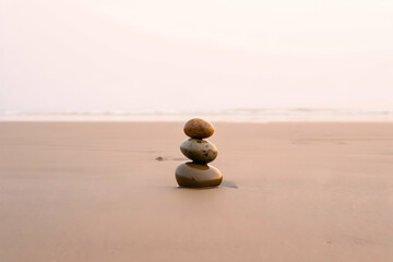 Tranquil Stones Balanced on Serene Beach Sand