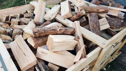 Heap firewood stack, natural wood. Cut firewood top view. Stock of firewood for heating house.