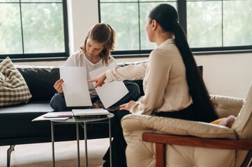 Papers with copy space. Girl at a psychologist's appointment