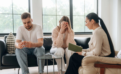 Woman is crying. Couple are at psychologist appointment