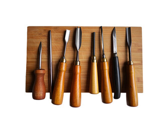 Collection of eight wood carving tools with wooden handles and metal blades arranged on a light brown bamboo cutting board isolated on a transparent background