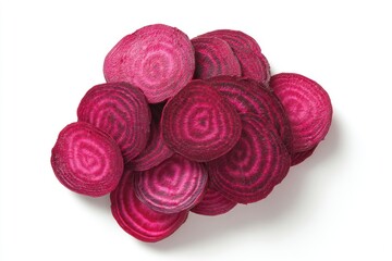 A pile of sliced beets reveals vibrant concentric rings of deep purple and red The slices overlap on a white surface with shadows