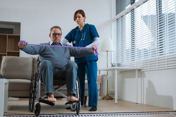 senior man doing exercise at clinic with physiotherapist. help of a therapist trainer during a...