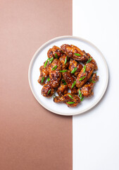 Chicken wings in teriyaki sauce with sesame and onion. Asian food.