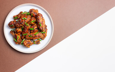 Chicken wings in teriyaki sauce with sesame and onion. Asian food.