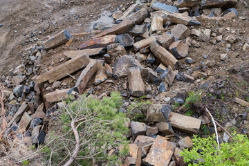 Basaltic rocks on bottom of basalt quarry in overcast day