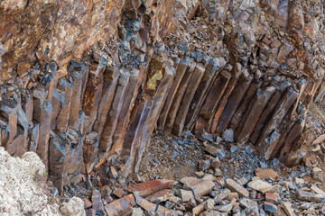 Basaltic columns in wall of basalt quarry in overcast day